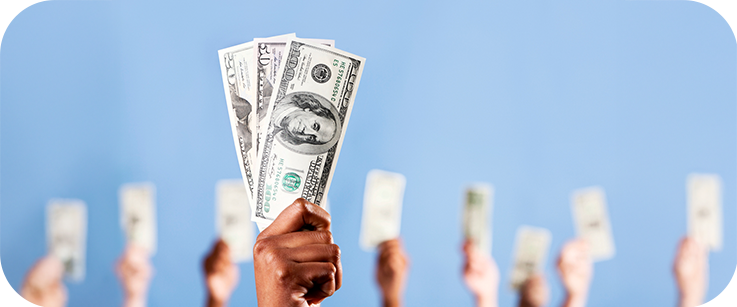 Hands holding up cash in the air