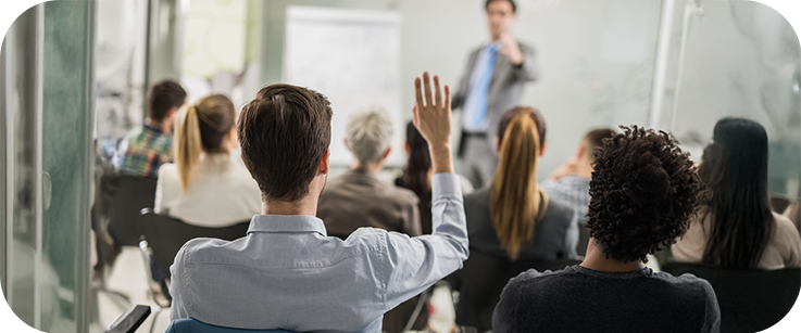 Man raising his hand to ask a question