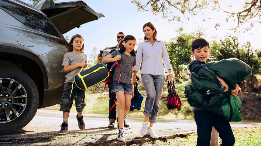 Family unpacking their items from their Chevrolet SUV