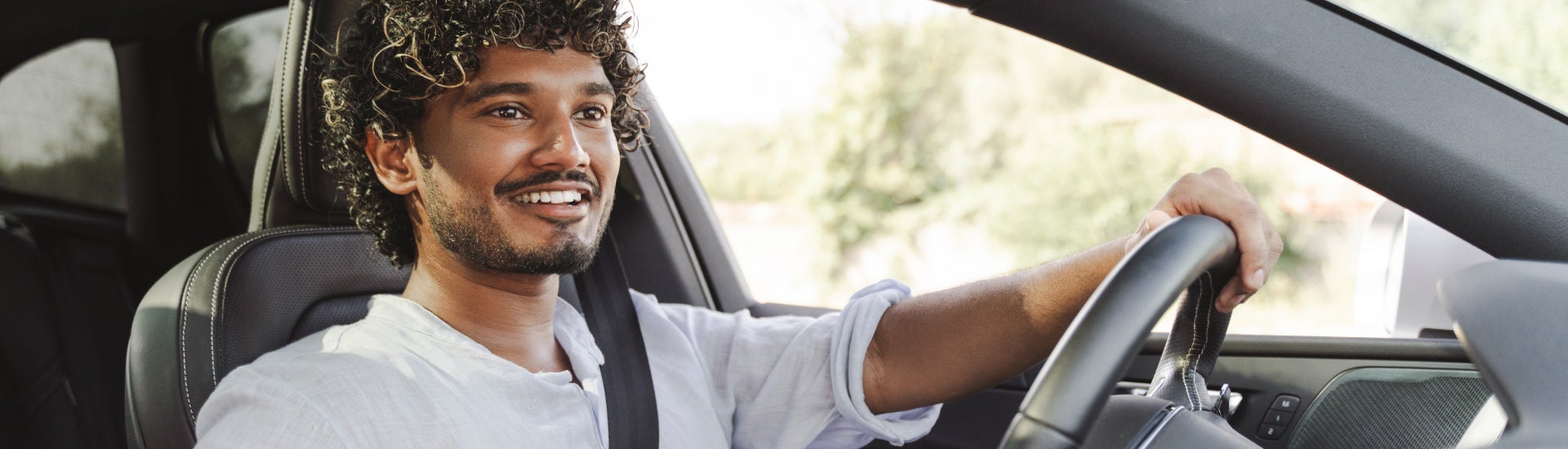 A man driving off in his new Chevrolet vehicle